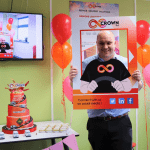 staff member holding a branded photo board