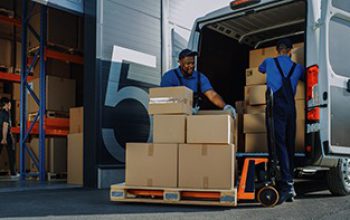 Outside,Of,Logistics,Warehouse,With,Open,Door,,Delivery,Van,Loaded Outside of Logistics Warehouse with Open Door, Delivery Van Loaded with Cardboard Boxes. Truck Delivering Online Orders, Purchases, E-Commerce Goods, Wholesale Merchandise.