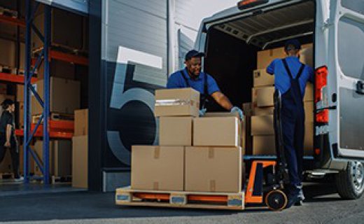 Outside of Logistics Warehouse with Open Door, Delivery Van Loaded with Cardboard Boxes. Truck Delivering Online Orders, Purchases, E-Commerce Goods, Wholesale Merchandise.