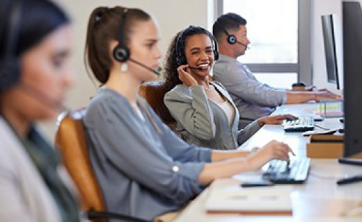 Portrait, woman and colleagues in a call center office for customer service, consulting and business crm. Female advisor and staff, inbound telemarketing and microphone to listen, help and support