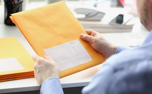 Man,Hold,Envelope,,Prepare,Package,To,Give,To,Courier,For Man hold envelope, prepare package to give to courier for further delivery