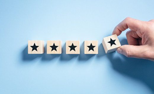 Customer experience feedback rate satisfaction experience five star rating placing wooden blocks on blue background