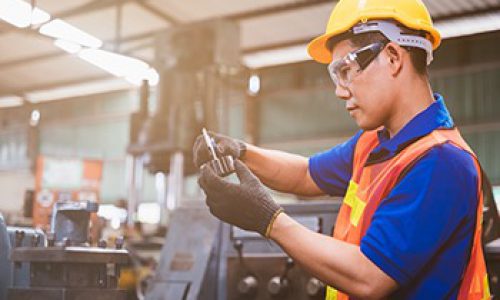 Industry factory maintenance engineer wearing uniform and safety helmet under inspection and checking production process on factory station on machinery. Industry, Engineer, construction concept.